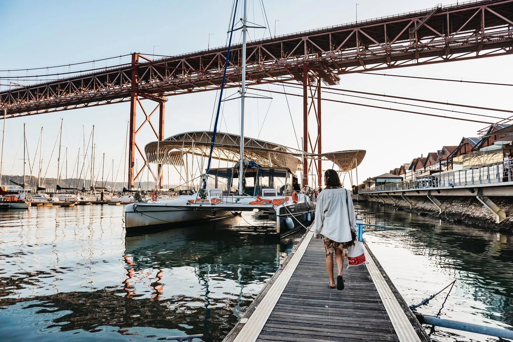 Catamarans at Doca de Santo Amaro beside the 25 de Abril Bridge in Lisbon